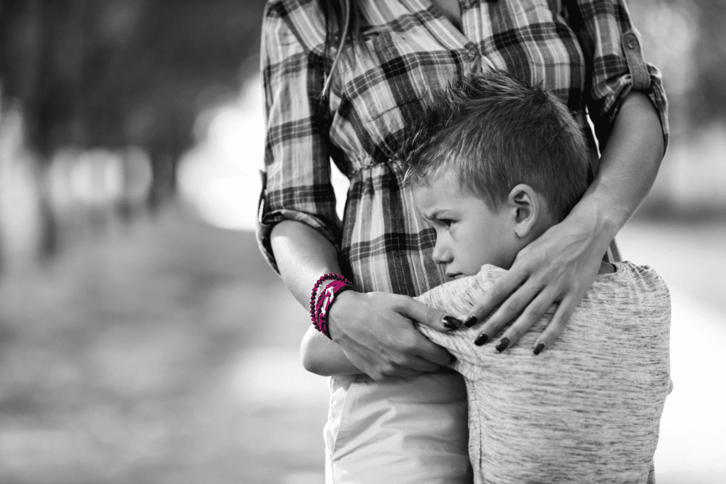 Young child hugging parent